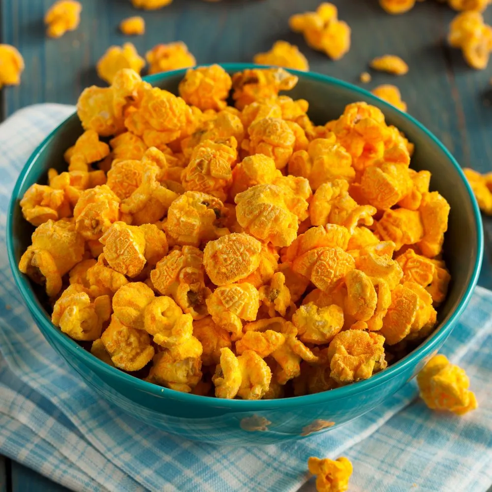 Bright yellow popped War Eagle Mill popcorn in a teal bowl