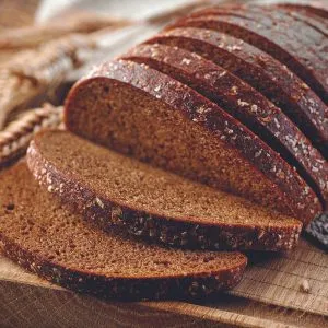 Sliced loaf of homemade rye bread made with Organic Rye Flour – dark, hearty, and rich in flavor