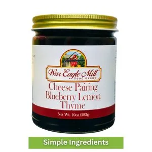 Glass jar of War Eagle Mill Blueberry Lemon Thyme Cheese Pairing Spread – 10 oz, made with simple ingredients.