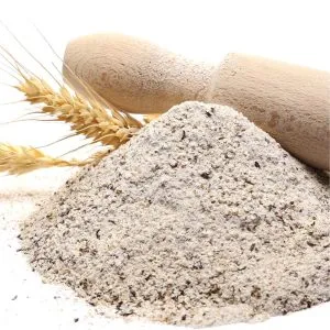 Pile of Organic Buckwheat Flour with wheat stalks and wooden rolling pin on white background