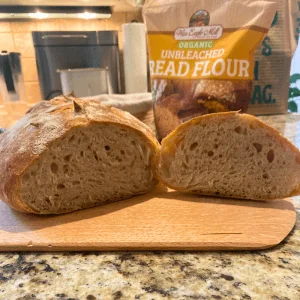Organic Bread Flour – Artisan Loaf Sliced bread made with War Eagle Mill organic unbleached bread flour, showcasing a soft interior and crusty exterior, with the flour bag in the background.