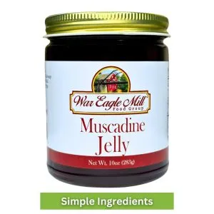 Jar of War Eagle Mill Muscadine Jelly with a gold lid and clean label, featuring simple ingredients.