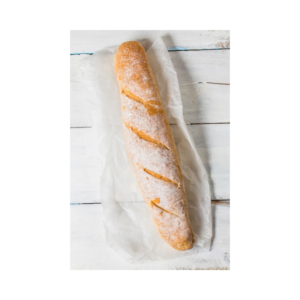 Country French Bread with golden crust and flour-dusted top – artisan-style loaf on parchment paper
